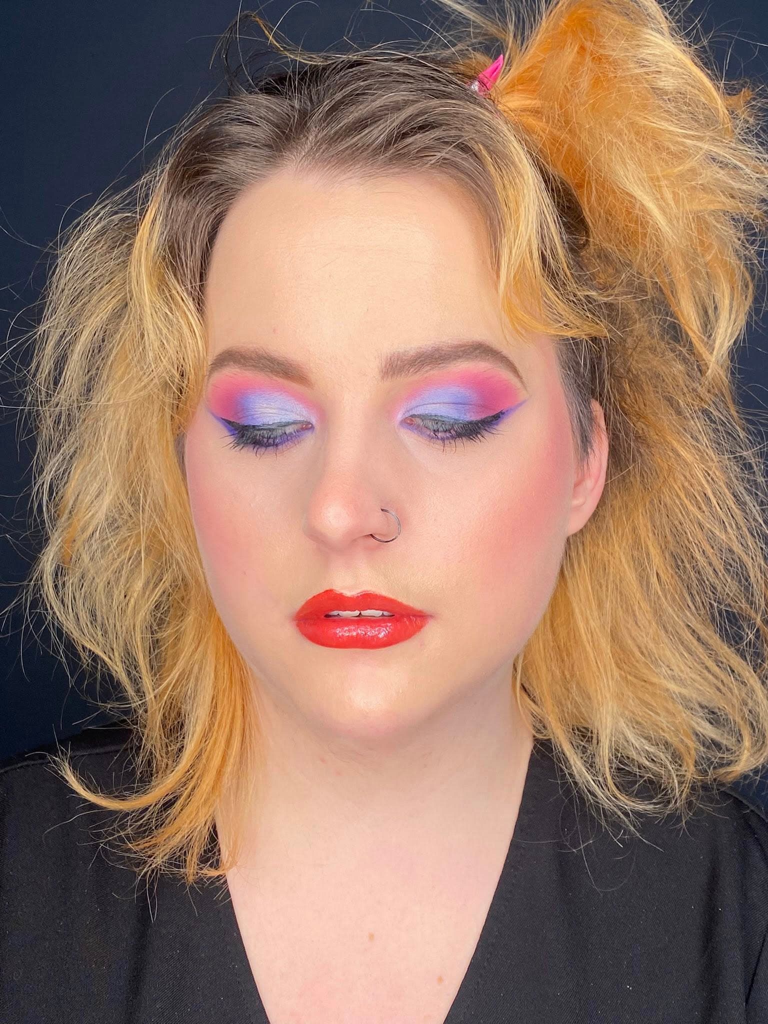 Colorful beauty makeup with styled blonde hair.