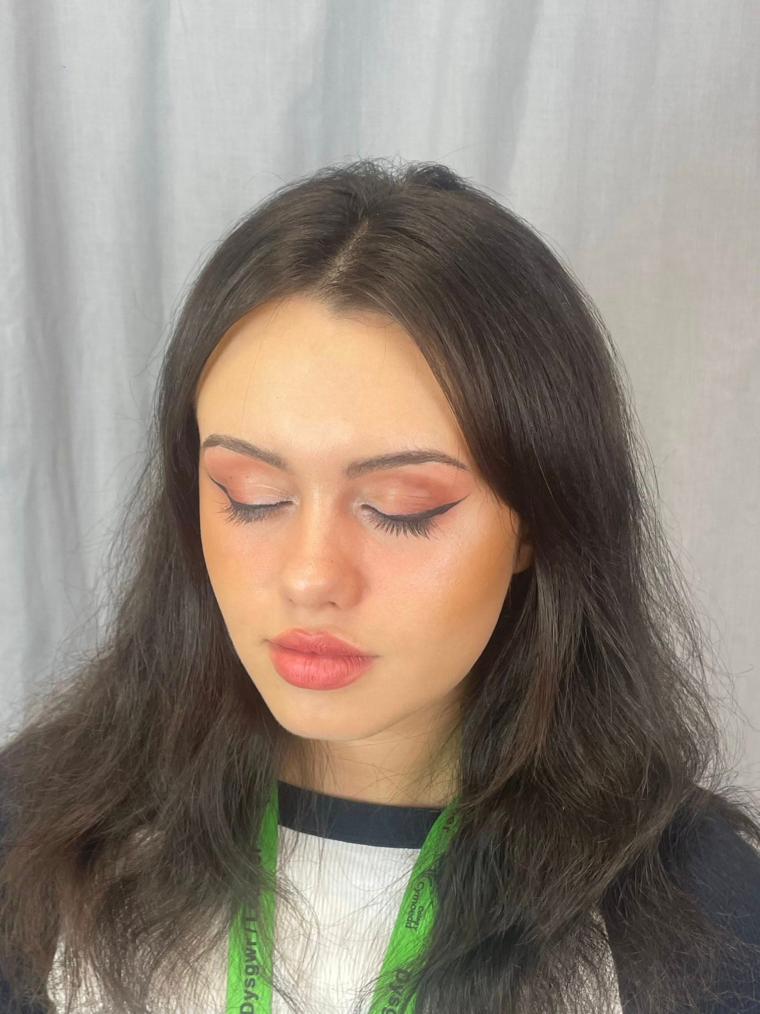 Soft glam hair and makeup look with dark hair.