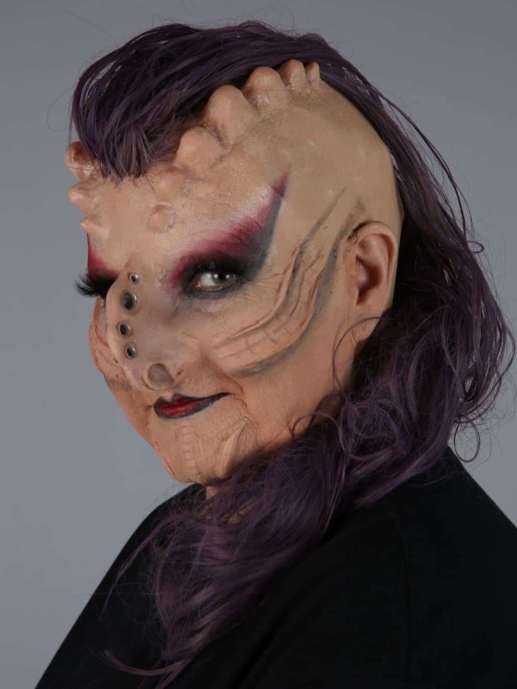 Creature special effects makeup with sculptural prosthetics.
